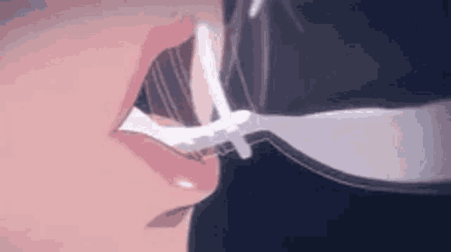 a close up of a person 's mouth with a bottle of milk coming out of it .