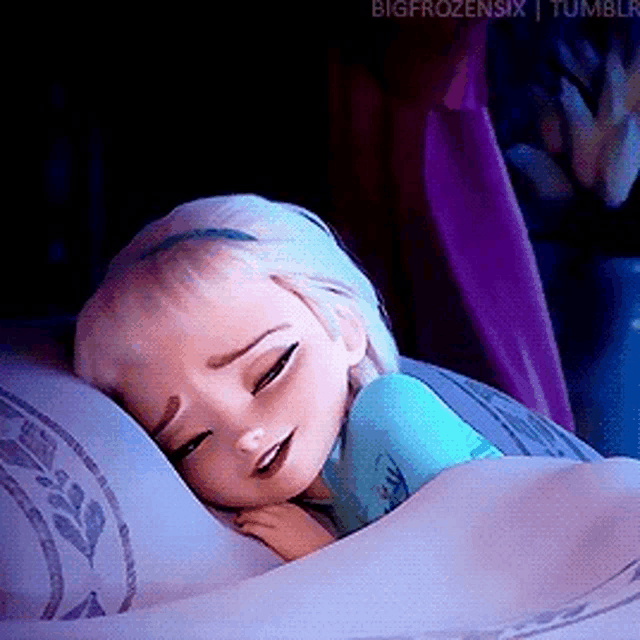 a little girl is sleeping on a pillow with her eyes closed .