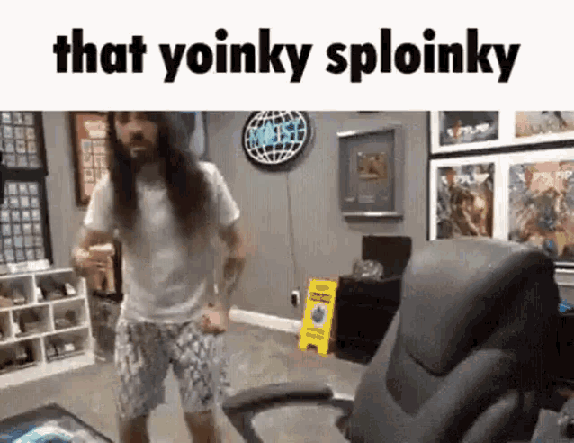 a man with long hair and a beard is dancing in a living room next to an office chair .