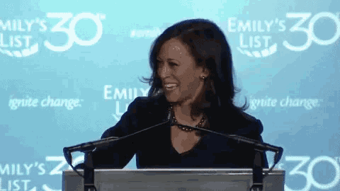 a woman stands at a podium with emily 's 30 on the back