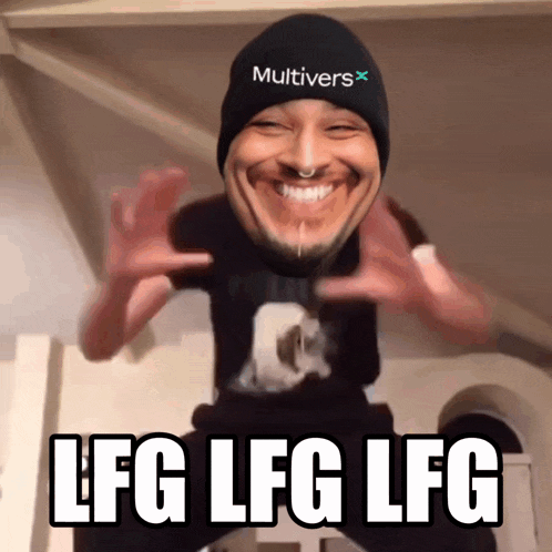a man wearing a beanie that says multivers on it is smiling and says lfg lfg lfg