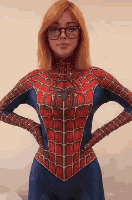 a woman wearing glasses and a spiderman costume with her hands on her hips