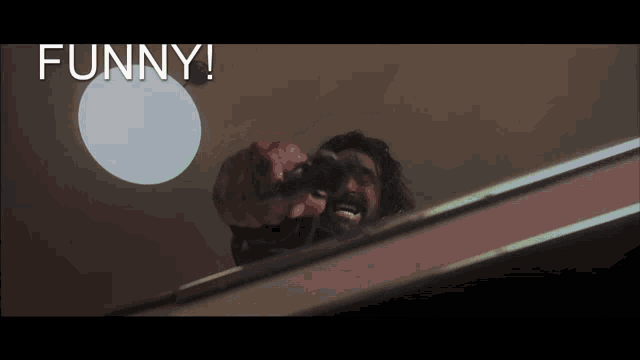 a man holding a gun with the words funny written above him