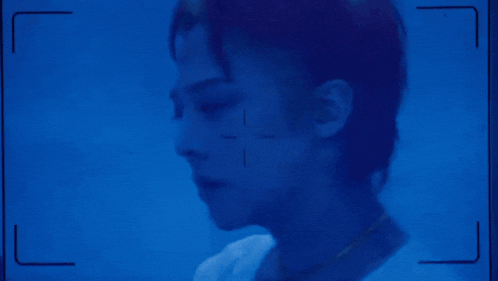 a close up of a person 's face with a cross on it