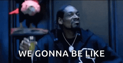 snoop dogg is holding a glass of champagne in his hand and saying `` we gonna be like '' .