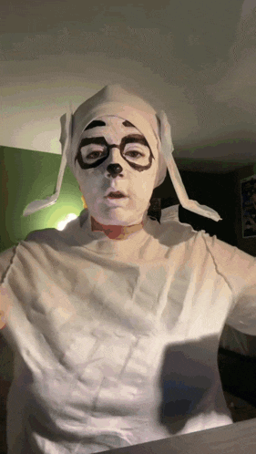 a person dressed in a mummy costume with glasses and a hat