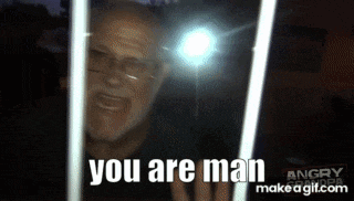 a man with glasses and a beard is looking through a window and says " you are man "
