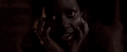 a close up of a woman 's face with a tear running down her face .