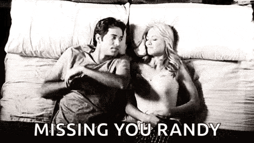a man and a woman are laying on a bed together .