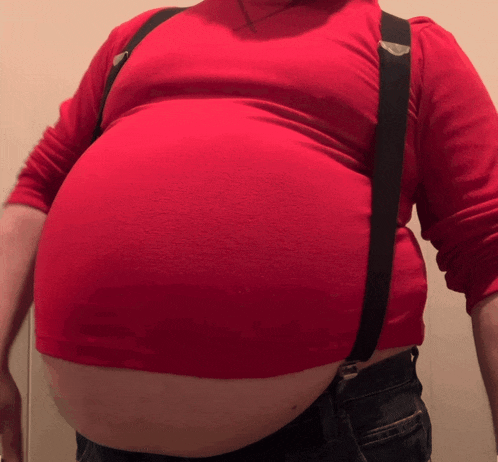 a person wearing suspenders and a red shirt