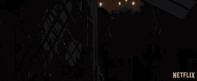 a person in a dark room with a netflix logo on the bottom