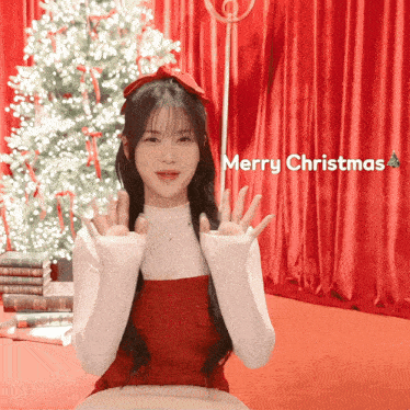 a girl in front of a christmas tree with merry christmas written on the bottom