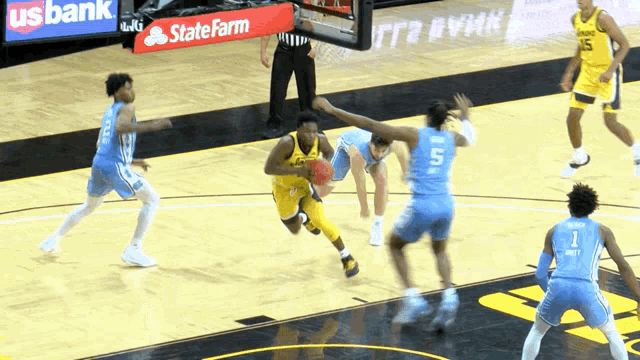 a basketball game is being played in front of a state farm sign