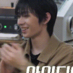 a close up of a person 's face with a blurry background and the word oii on the bottom right .