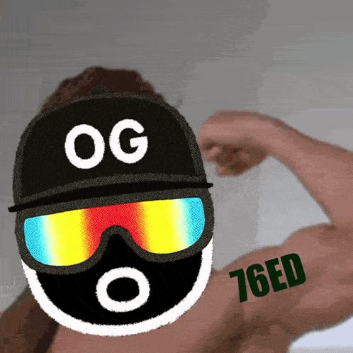 a man wearing sunglasses and a hat with og on it flexes his muscles