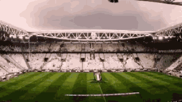 a soccer stadium with the word juventus on the roof