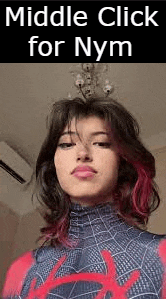 a woman with red hair is wearing a spiderman costume and making a funny face .