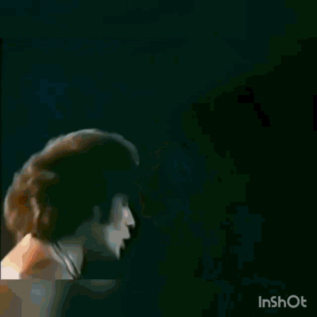 a man without a shirt is dancing on a stage in a video .