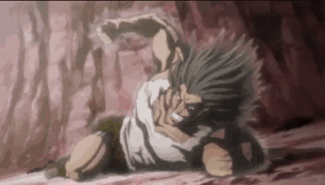 a man is laying on the ground in a cave with blood coming out of him .