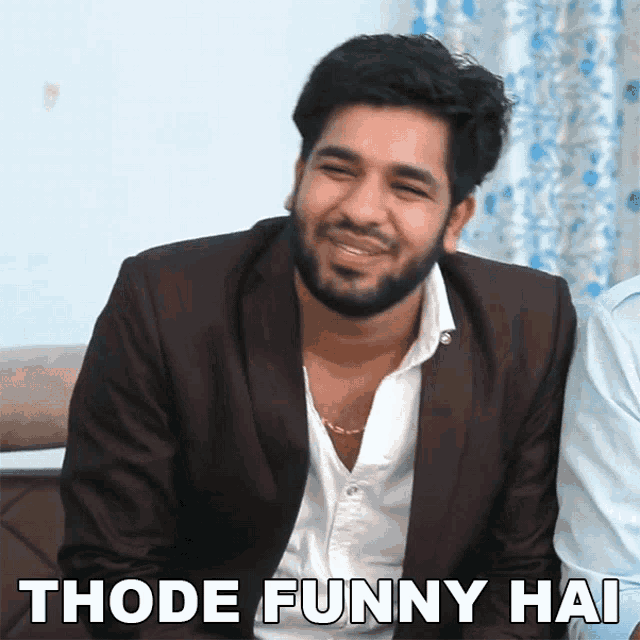 a man in a suit and white shirt is smiling with the words thode funny hai below him