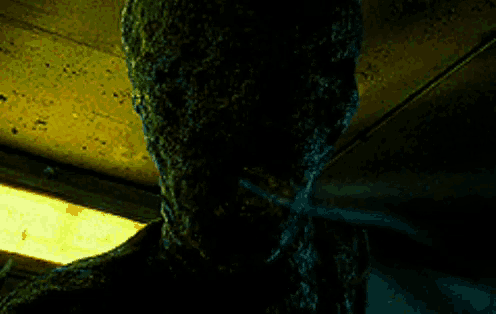 a man wearing glasses is being attacked by a monster