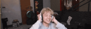 a young man is wearing headphones and smiling .