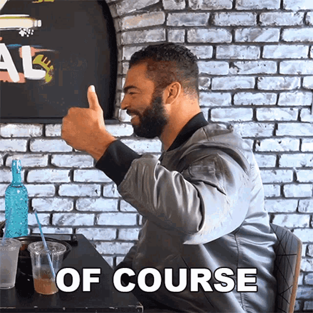 a man giving a thumbs up with the words of course behind him