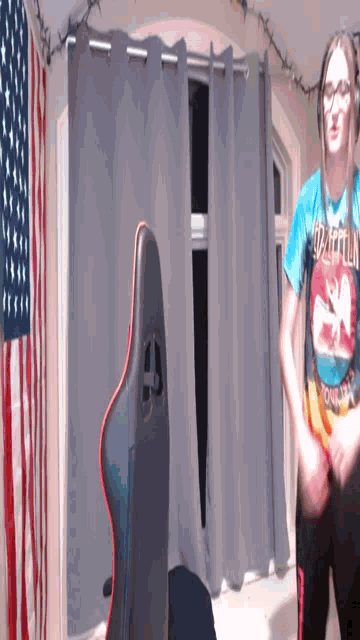 a person wearing a zeppelin shirt is standing in front of an american flag