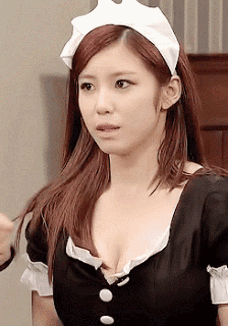 a woman in a maid costume has a very large cleavage