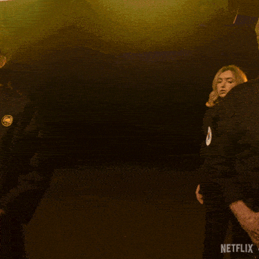 a woman in a black karate uniform is standing in front of a netflix sign