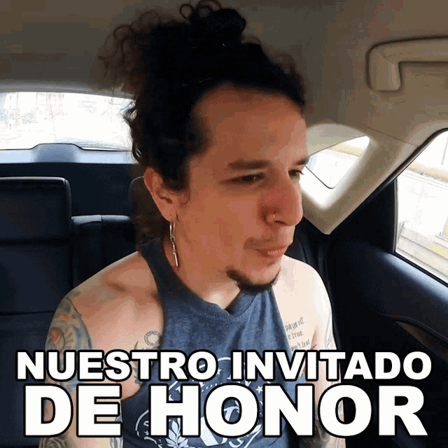 a man in a car with the words nuestro invitado de honor