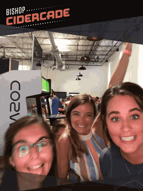 three girls are posing for a picture with the words bishop cidercade behind them