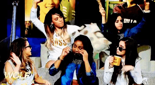 a group of women are sitting on a couch with the word wolf on the bottom