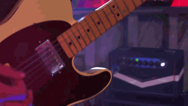 a man singing into a microphone and playing a guitar