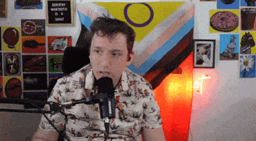 a man speaking into a microphone with a sign behind him that says dorothy mantooth is a saint