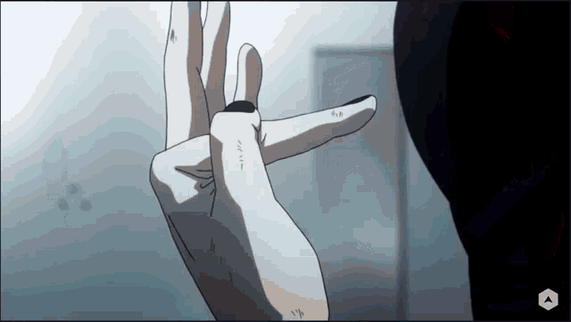 a person 's hand is shown with a black ring on their finger