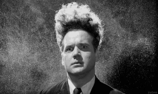 a black and white photo of a man in a suit and tie