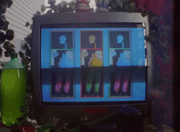 a bottle of green soda sits next to a tv screen