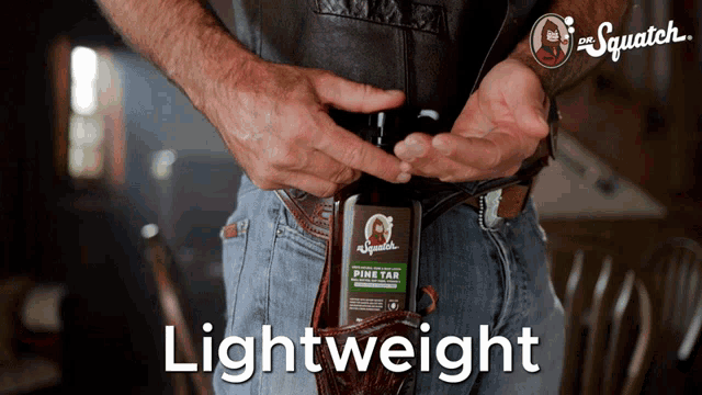 a man is holding a bottle of pine tar which is lightweight