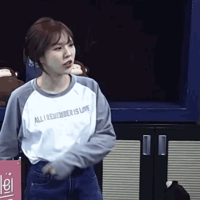 a woman wearing a t-shirt that says all i remember is love