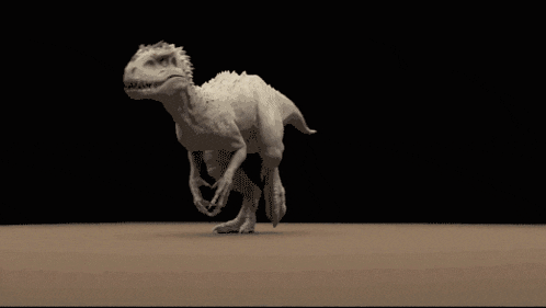 a dinosaur is walking across a sandy surface