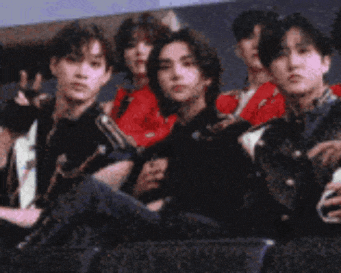 a group of people are posing for a picture and one of them is giving a peace sign