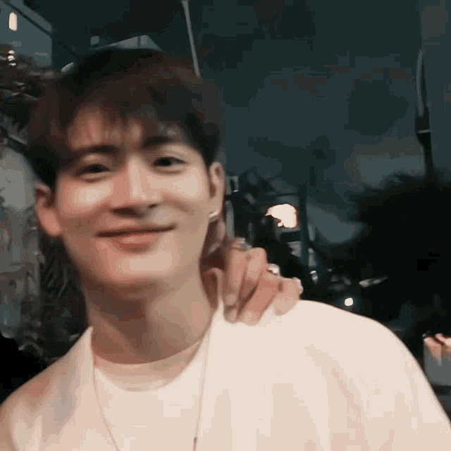 a man with his arm around another man 's neck