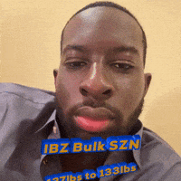 a man with a beard is wearing a blue shirt that says ibz bulk szn