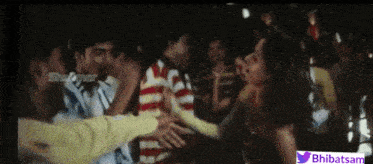 a group of people are dancing in front of a screen that says bhbatsam on it