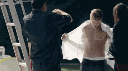 a shirtless man is being helped by a woman