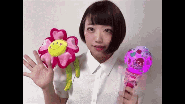 a girl is holding a stuffed flower and a glowing wand