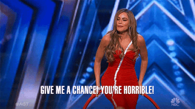 a woman in a red dress on a stage with the words give me a chance you 're horrible