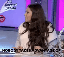 a woman with long hair is sitting in front of a screen that says the morning breath