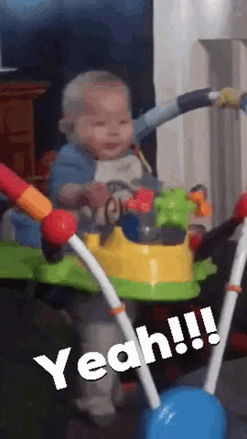 a baby is sitting in a walker with the word yeah written on the bottom